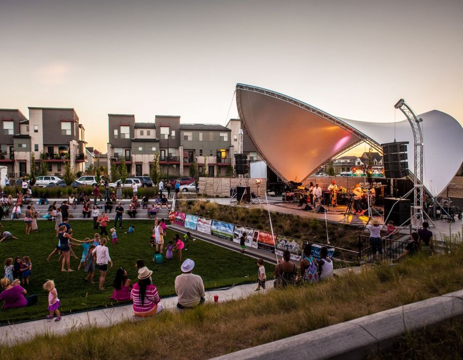 Outdoor concert with families attending in a grassy open area