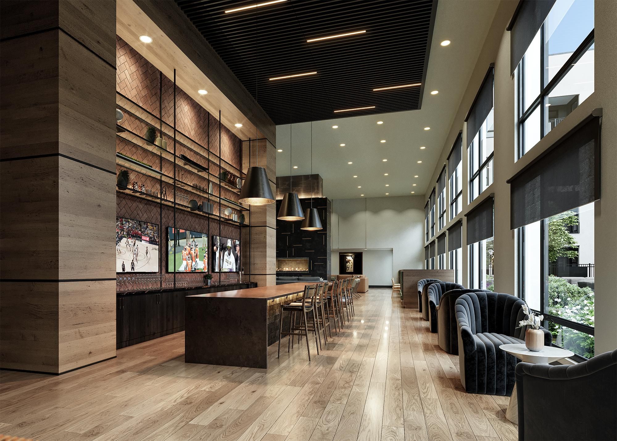 Modern bar area in Solana Central Park featuring dark wood tones, pendant lighting, and a series of screens displaying sports.